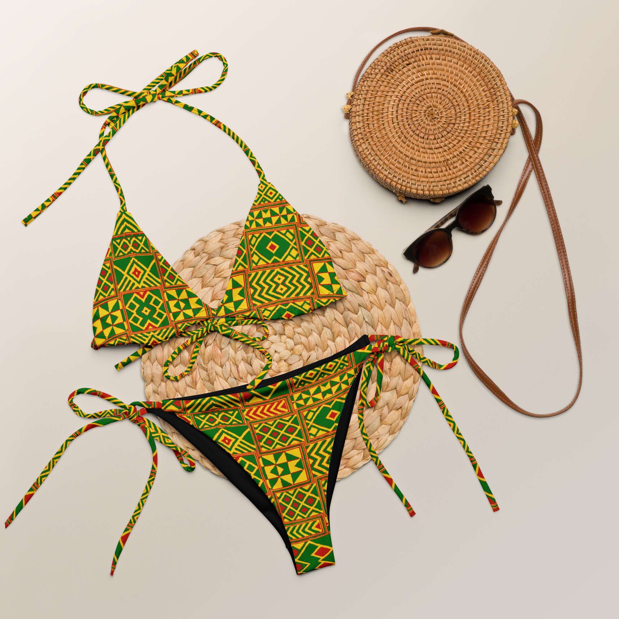 Rasta Kente string bikini styled flat view inspired by the beautiful Kente cloth of Africa in muted Rastafarian colors. Soft and stretchy in sizes up to 6XL.