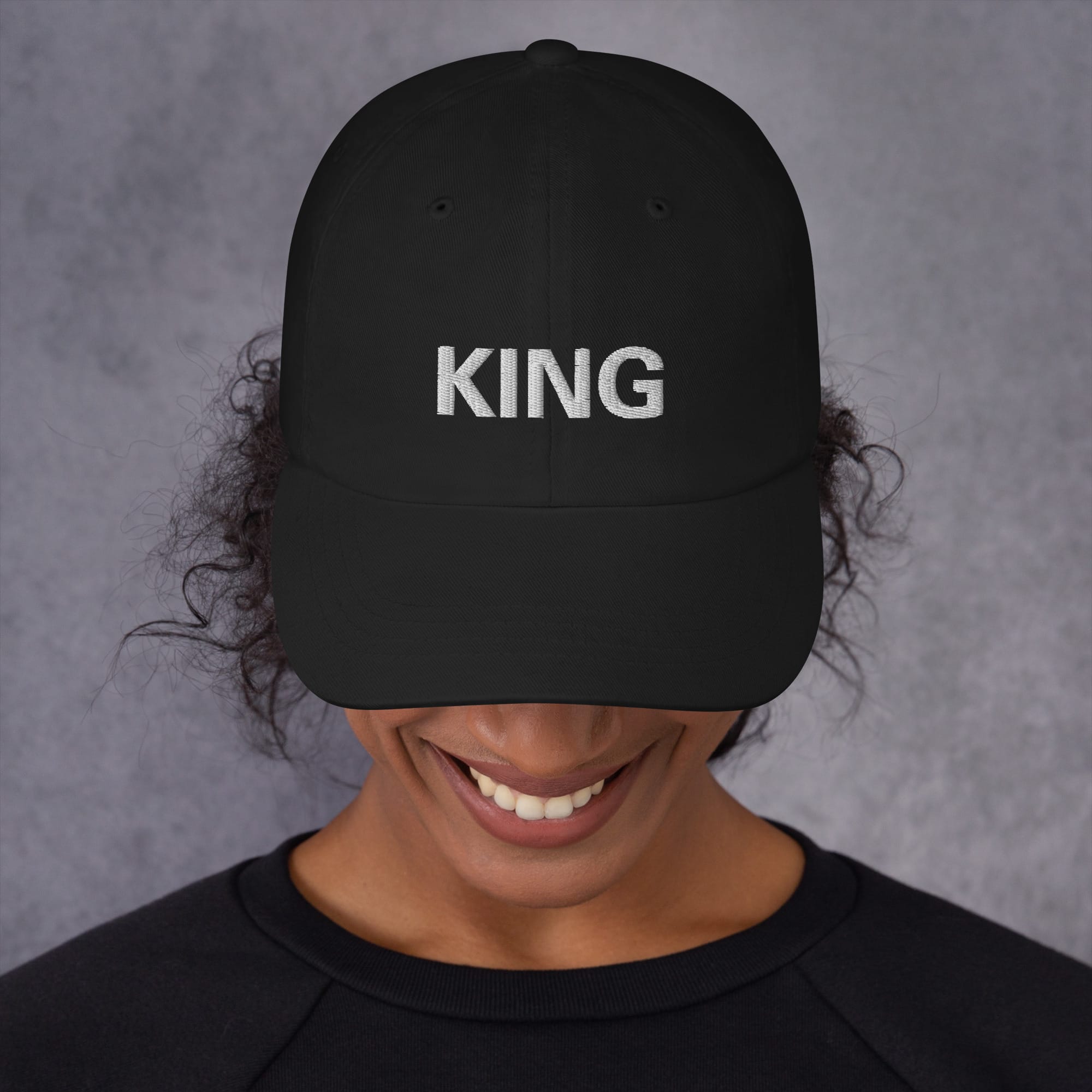King Rasta Cap in khaki or black. Original Jamaican designs at Rastaseed.com. Reggae gear and original Rastafarian clothing store. Front black model view.
