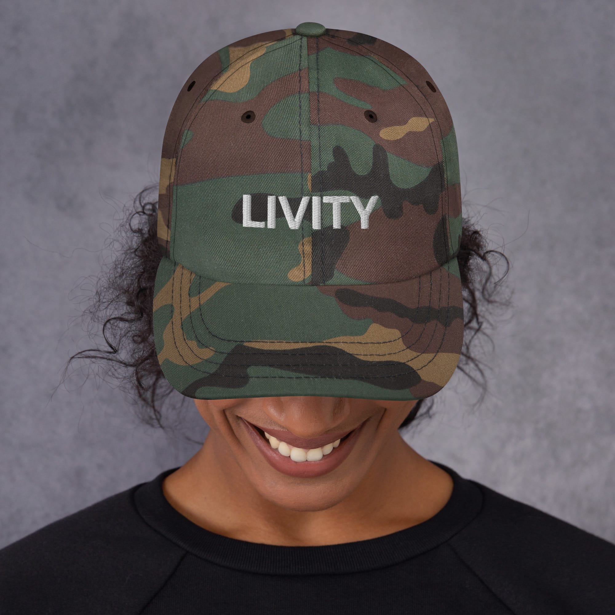 Livity Rasta Cap front view camo in khaki camouflage and black with embroidered lettering. Original Rasta merchandise and designs at Rastaseed clothing shop.Front model view camo.
