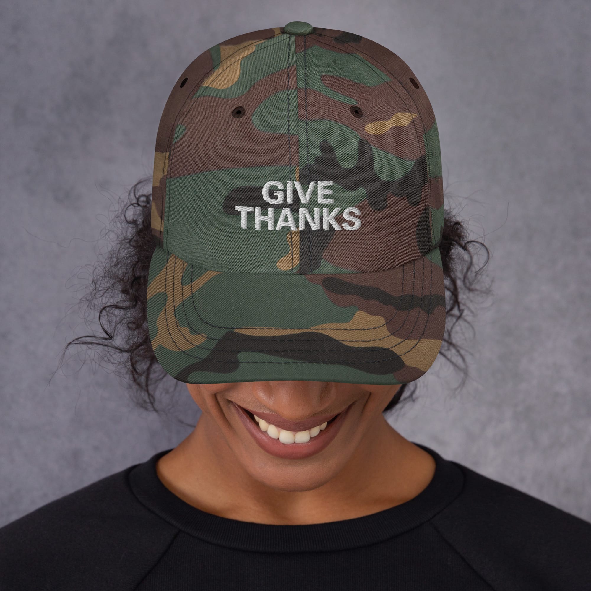 Give Thanks Rasta Cap front view camo available in khaki camoflage print and black colors. White embroidered lettering and dad hat style. Rastaseed original design. Front camo model view.